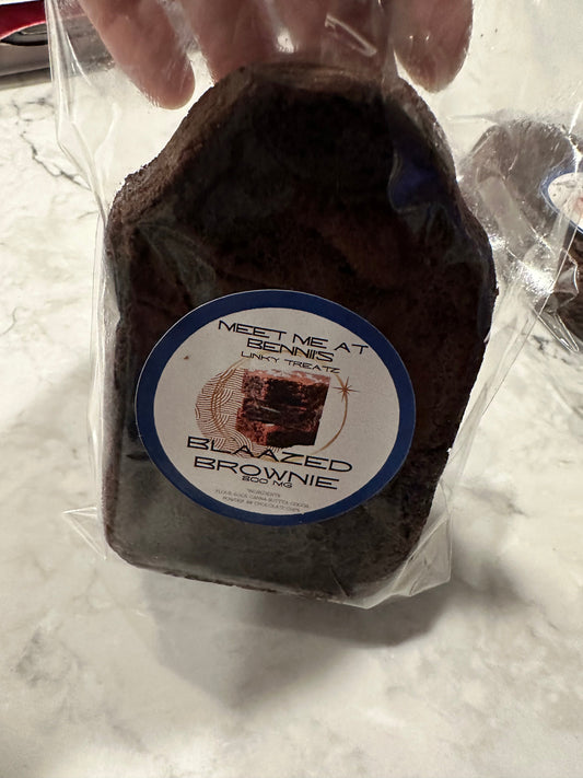 Shopify Blissful Brownie Delights with rich, fudgy texture and chocolate topping, displayed on a white plate.